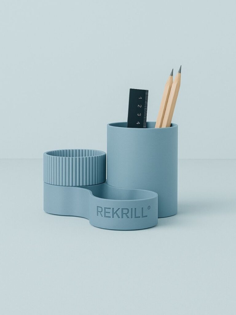 Rekrill light blue biopolymer pen holder on a table made of wood